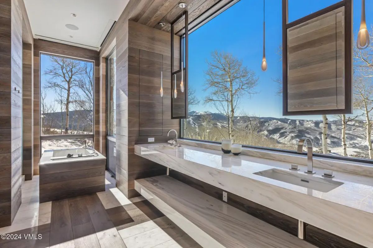 Designed with floor-to-ceiling windows showcasing expansive mountain scenery.