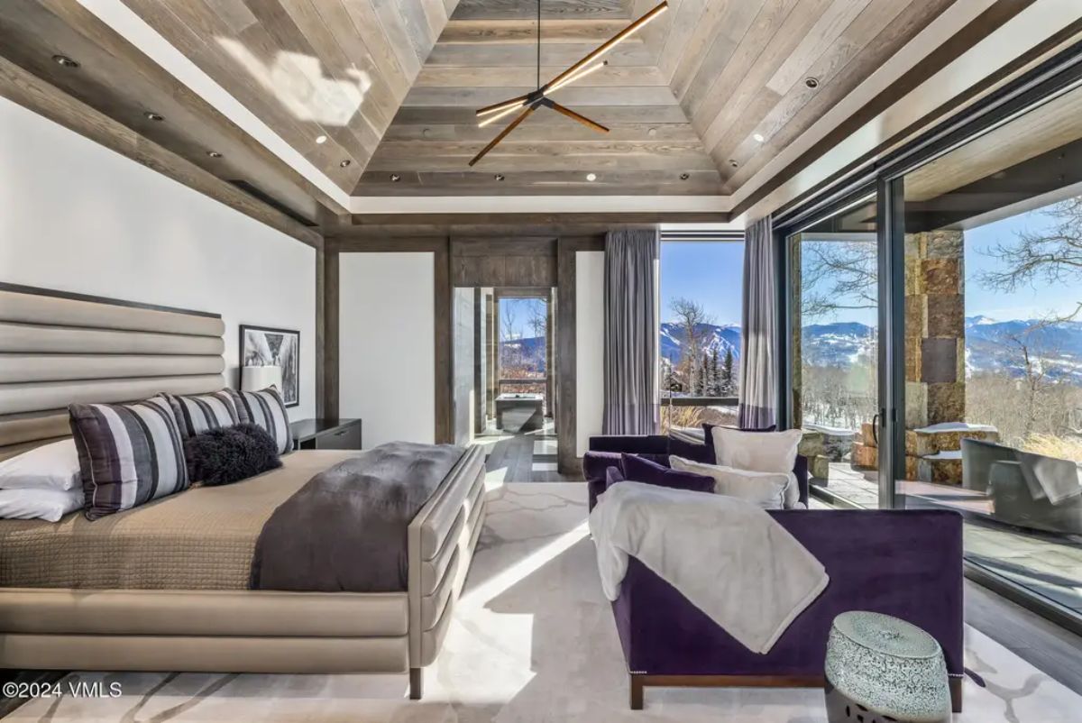Vaulted wooden ceiling with recessed lighting and a modern ceiling fan.