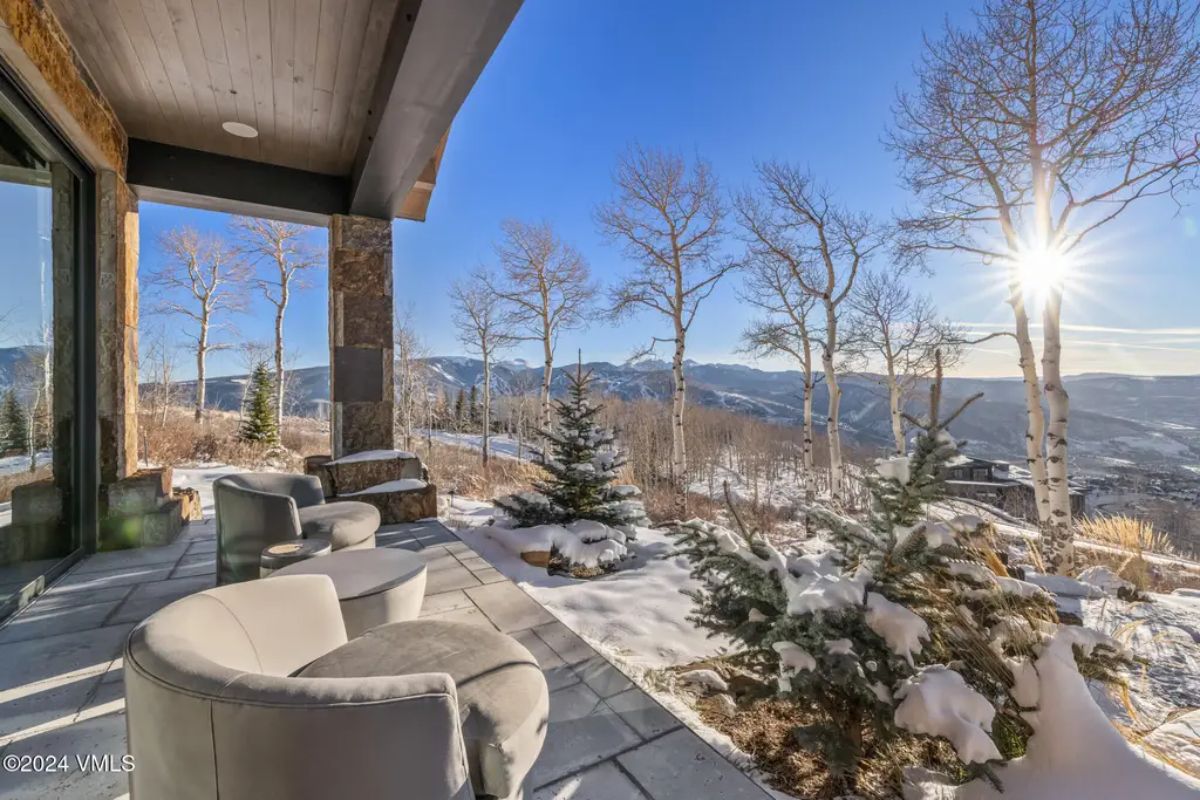 Outdoor patio space with a contemporary lounge chairs and stone flooring.
