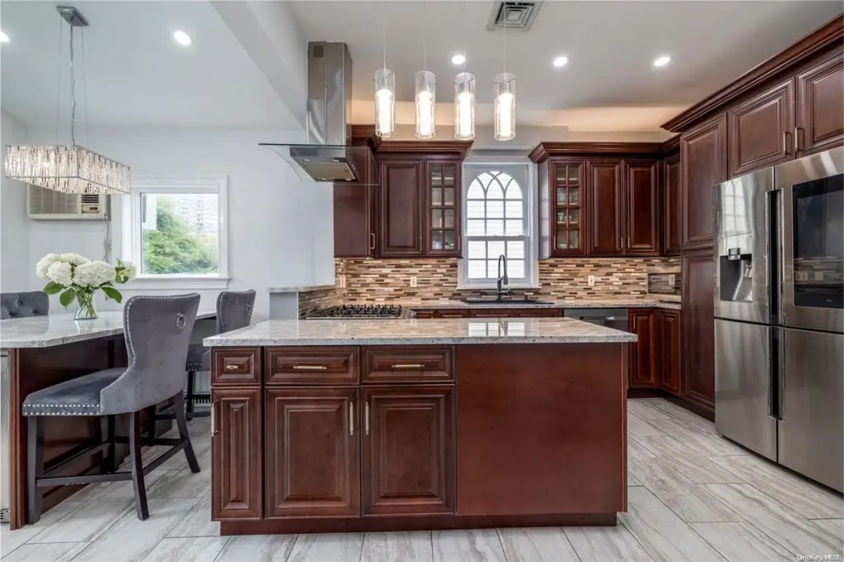 Dark wood cabinetry and granite countertops create a luxurious feel.