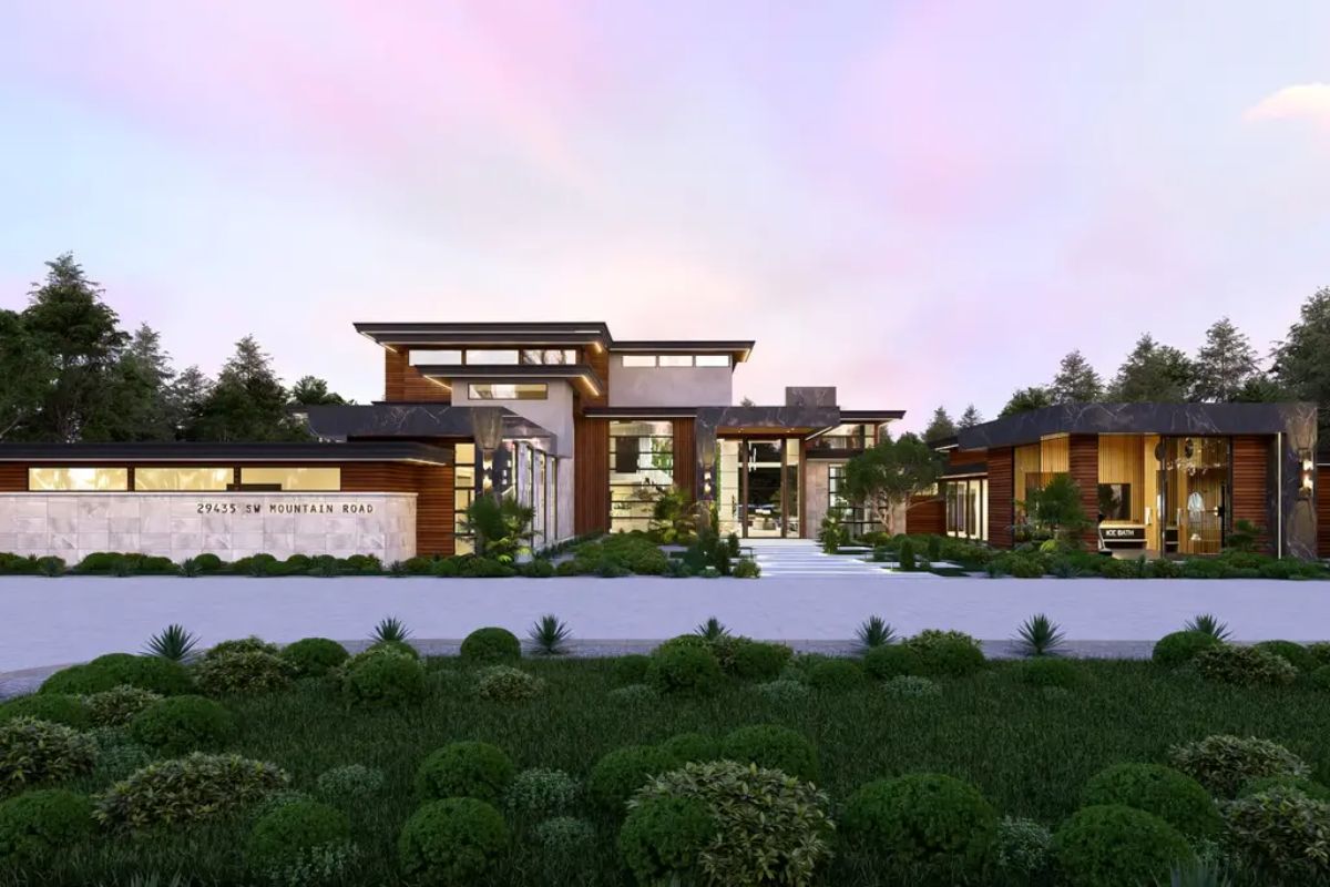 A contemporary estate showcases sleek architecture with large glass windows, wood paneling, and stone finishes.