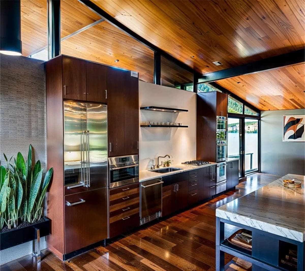 Contemporary kitchen highlights rich wood cabinetry, marble countertops, and modern open shelving. 