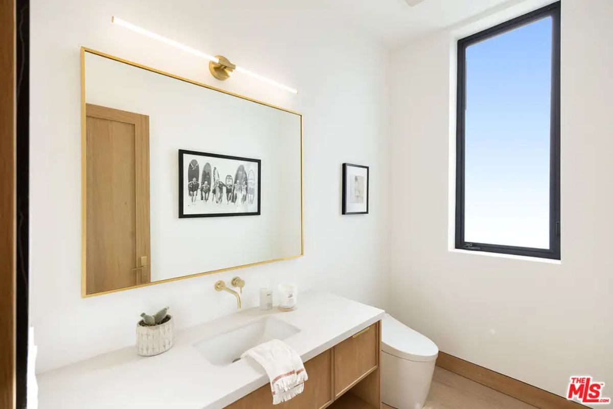 Powder room with a floating wood vanity and white quartz countertop.