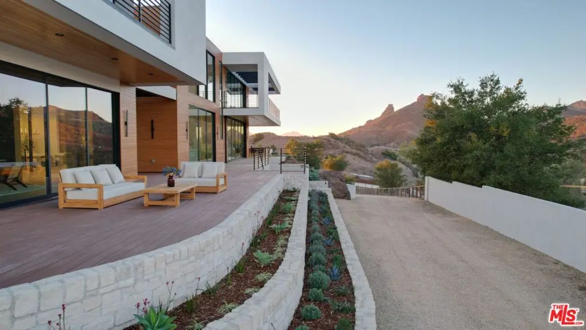 Expansive deck with wooden flooring and modern outdoor seating.