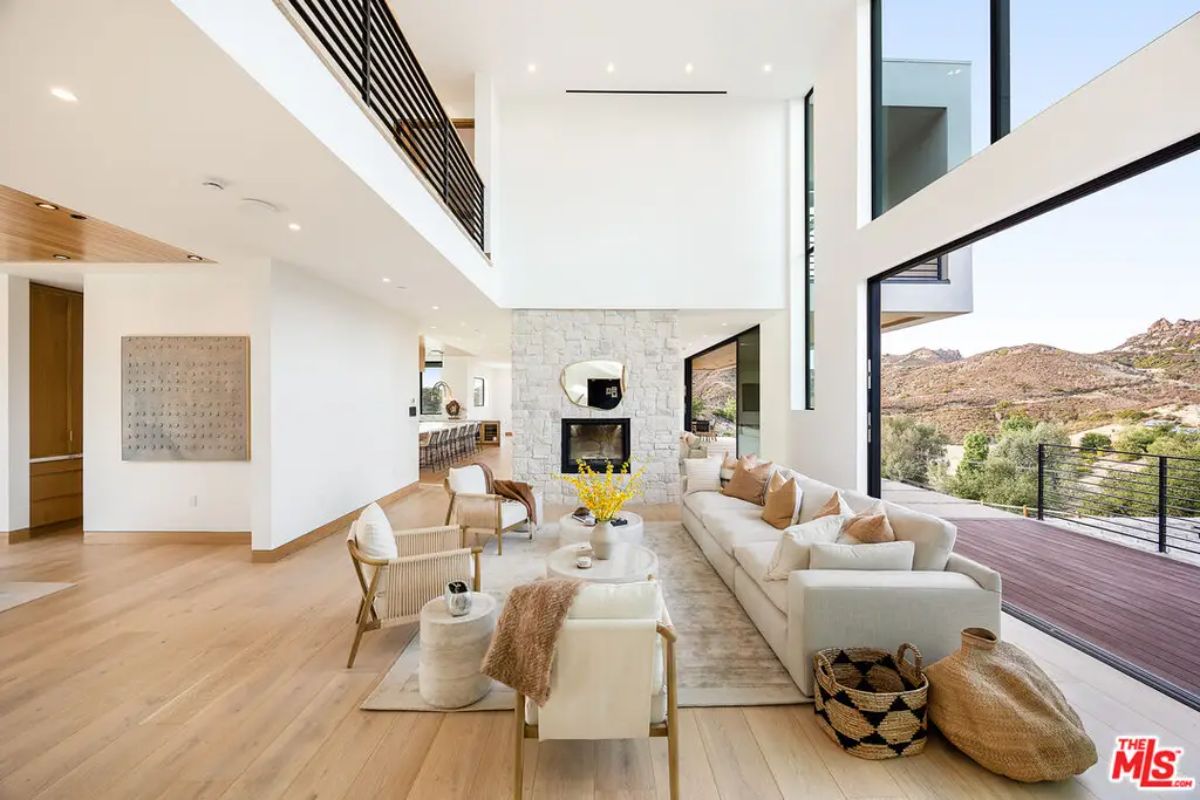 Living room with double-height ceilings and floor-to-ceiling windows.