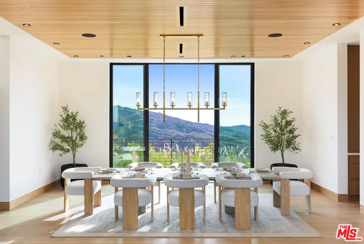 A wood-paneled ceiling and floor-to-ceiling windows.