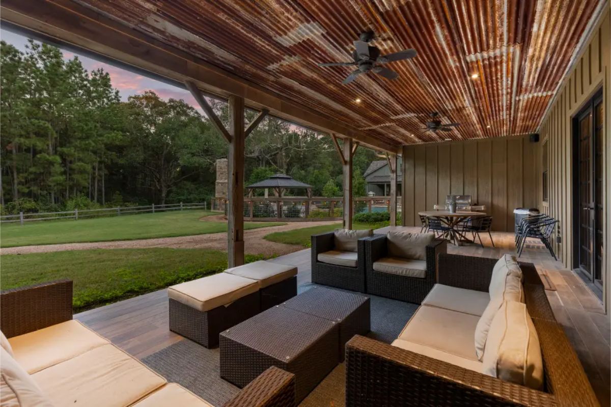 Outdoor space with a covered patio, rattan seating, and a dining area.