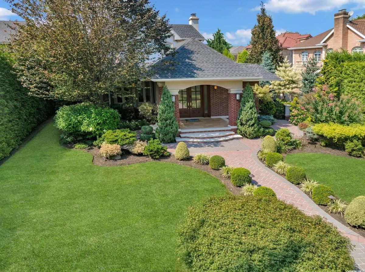 Priced at $4,695,000, this 4,622 sq ft custom contemporary home, built in 1925 and fully redesigned in 2013, is located in the exclusive waterfront neighborhood of Malba.
