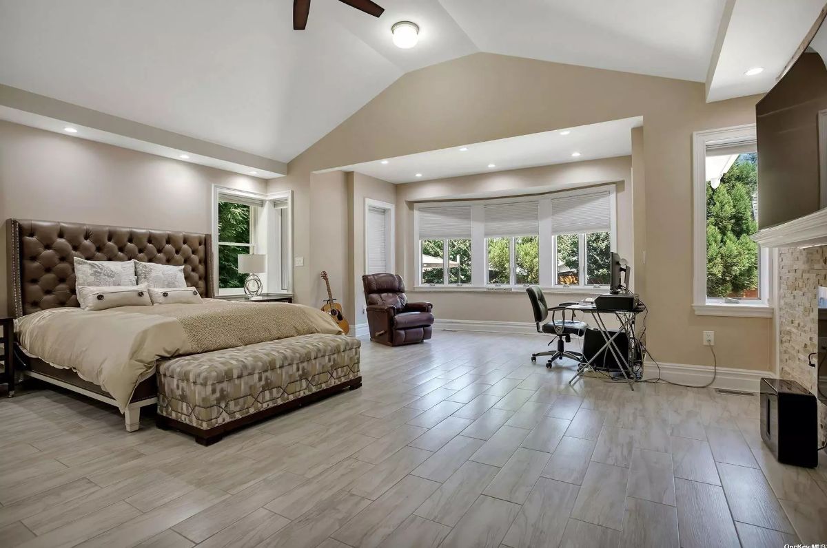 Bedroom with high ceilings and recessed lighting.