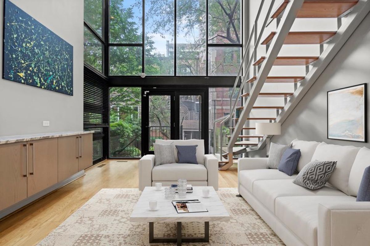 Glass walls provide natural light and an unobstructed view of the outdoor greenery.