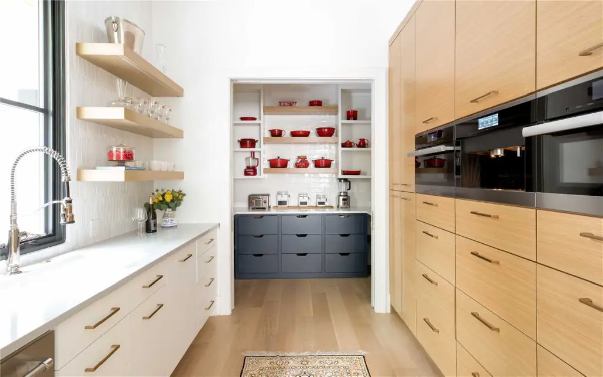 Butler’s pantry with open shelving, ample storage, and built-in appliances for extra kitchen space. 