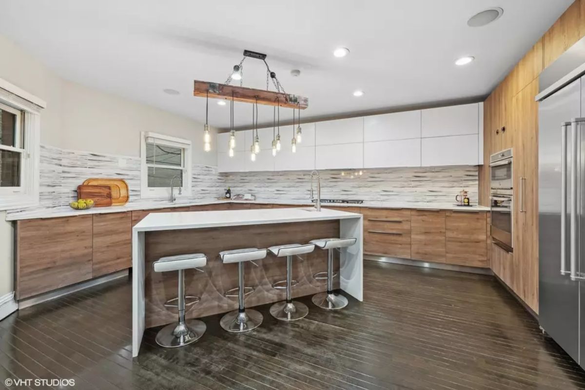 Wood and white cabinetry create a clean contrast in this open kitchen.