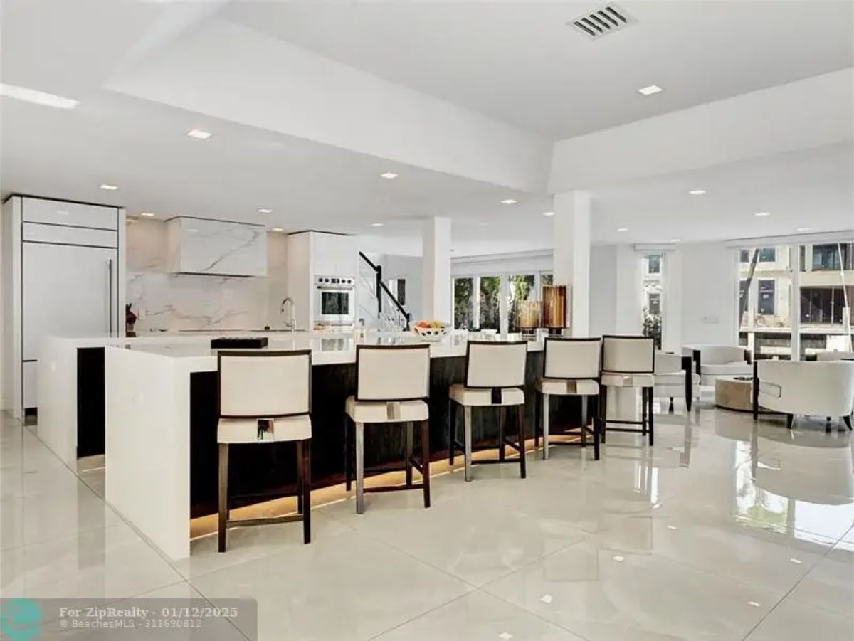 Spacious kitchen with a massive island, high-end appliances, and a modern open-concept design. 