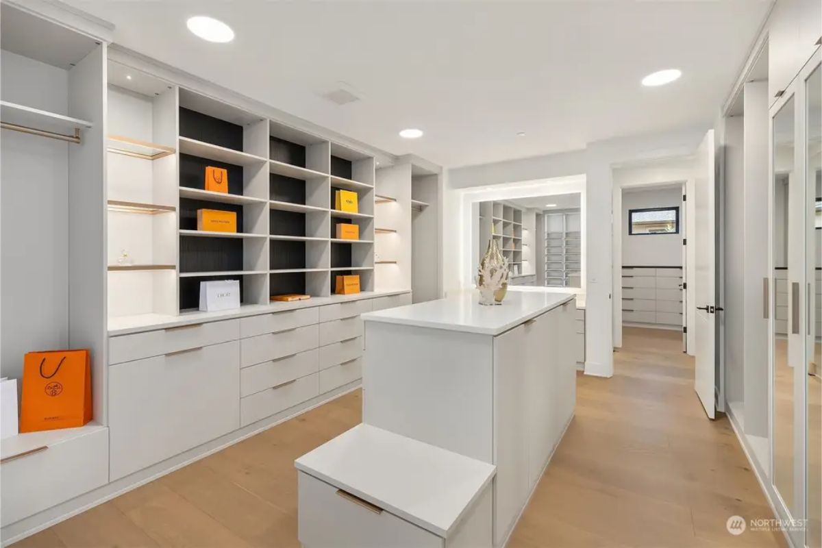 Expansive walk-in closet with custom shelving, built-in drawers, and luxury accents. 