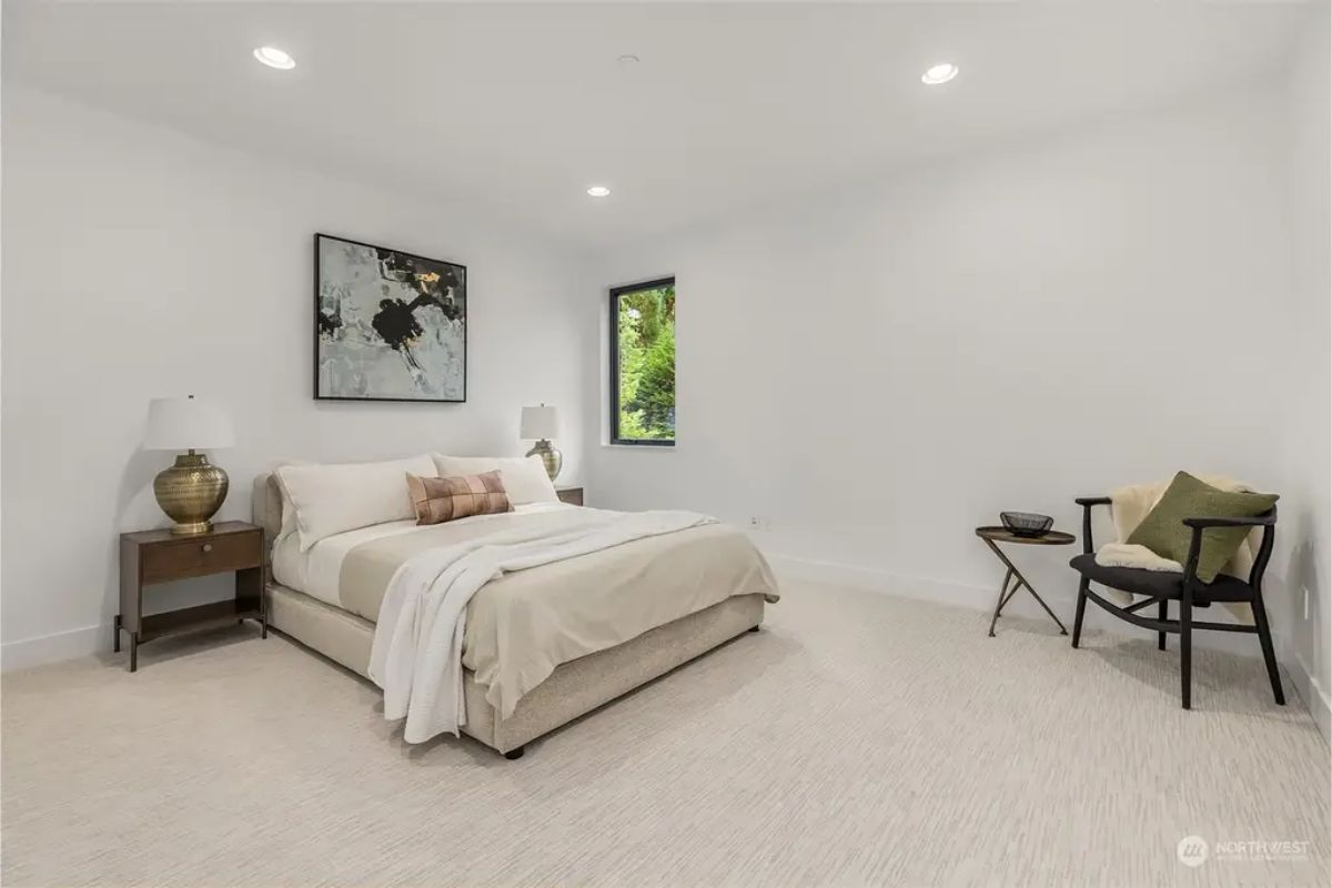 Cozy guest bedroom featuring minimal decor, soft lighting, and a peaceful ambiance. 