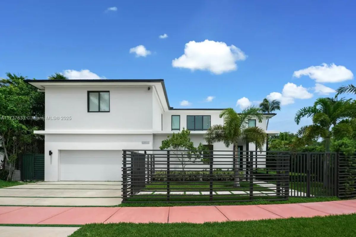 White stucco exterior with black-framed windows creates a sleek, minimalist aesthetic.