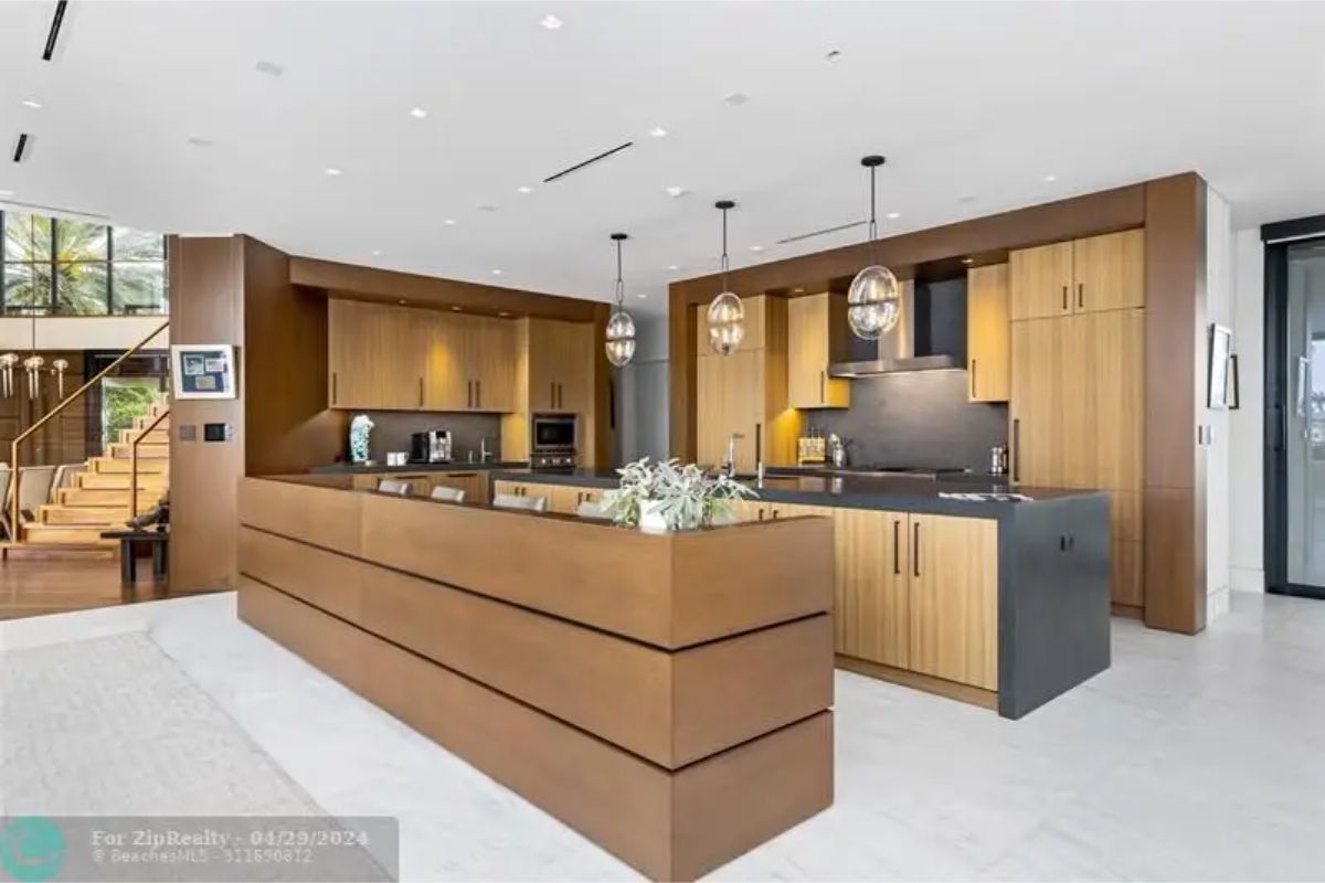 Modern kitchen with dual islands, wooden cabinets, and stainless steel appliances. 