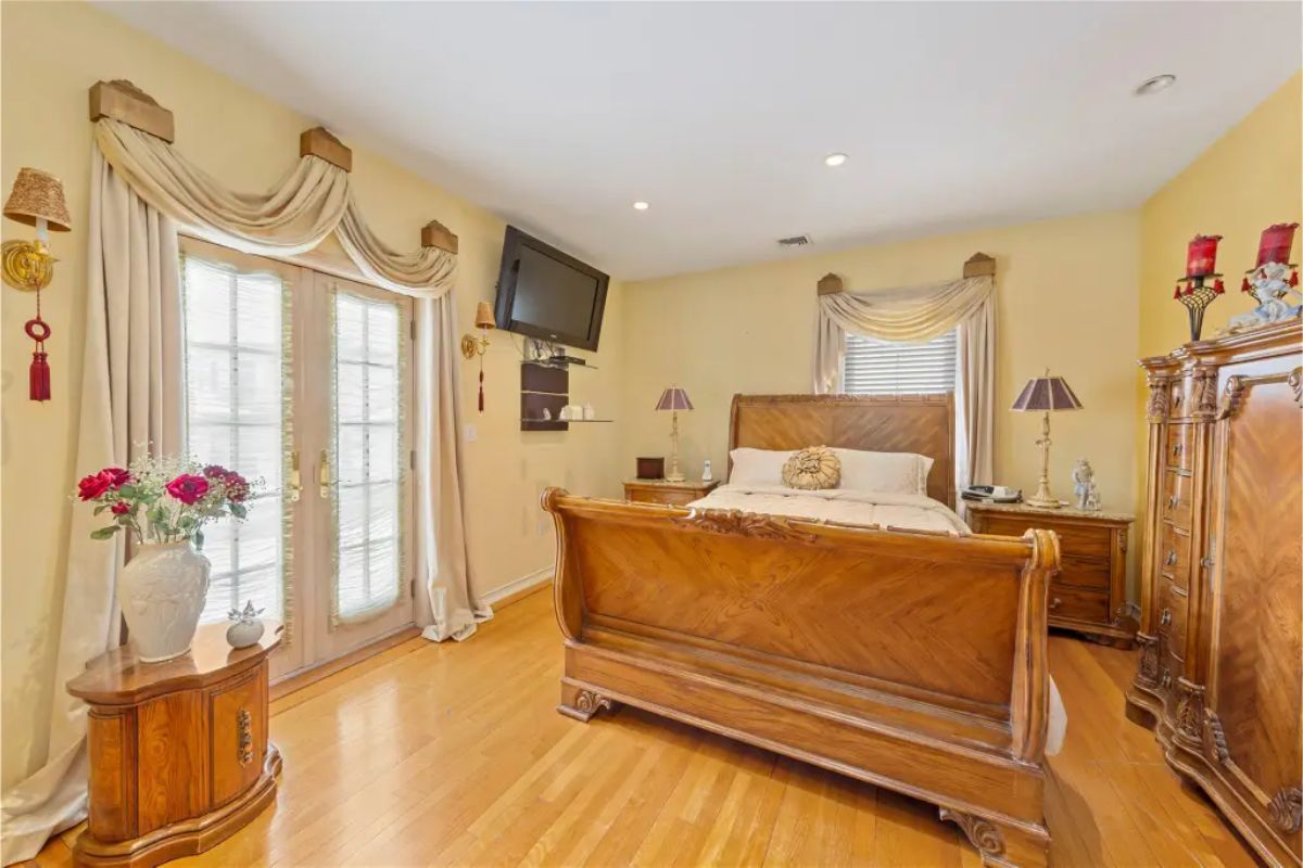 Bedroom showcases a wooden sleigh bed with matching nightstand and dresser.