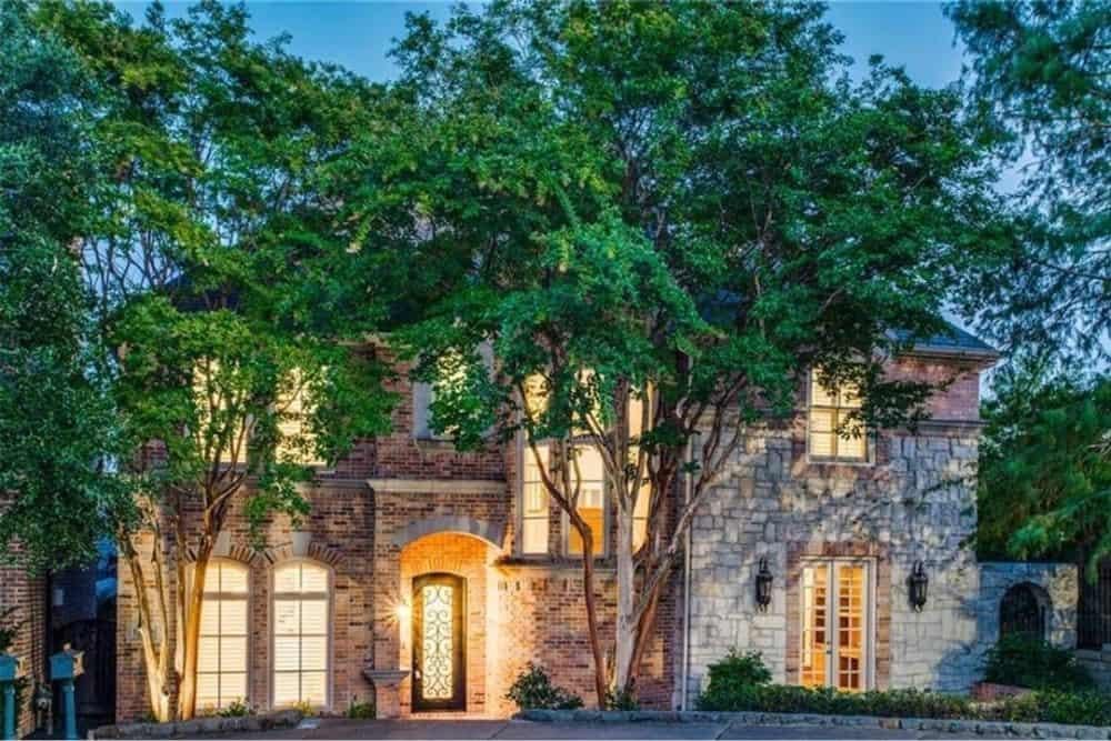 Charming Brick and Stone Facade Hidden Among Lush Trees