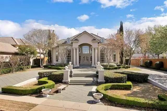 Grand Entrance with Symmetrical Columns and Manicured Gardens