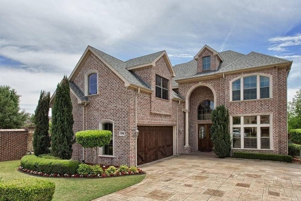 Traditional Elegance in a Brick Facade with Arched Entryway