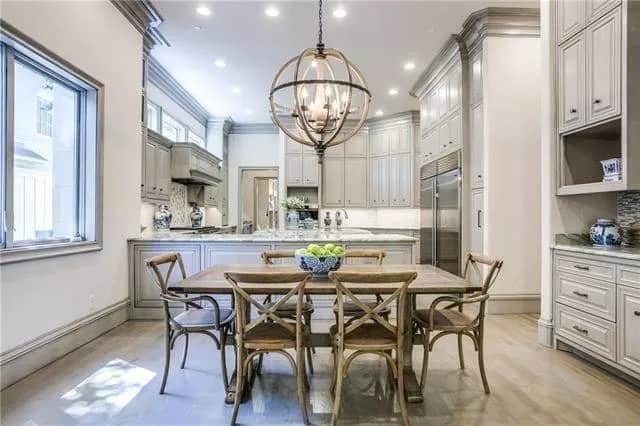 Kitchen Dining Area Highlights Elegant Cabinetry and a Globe Pendant Light