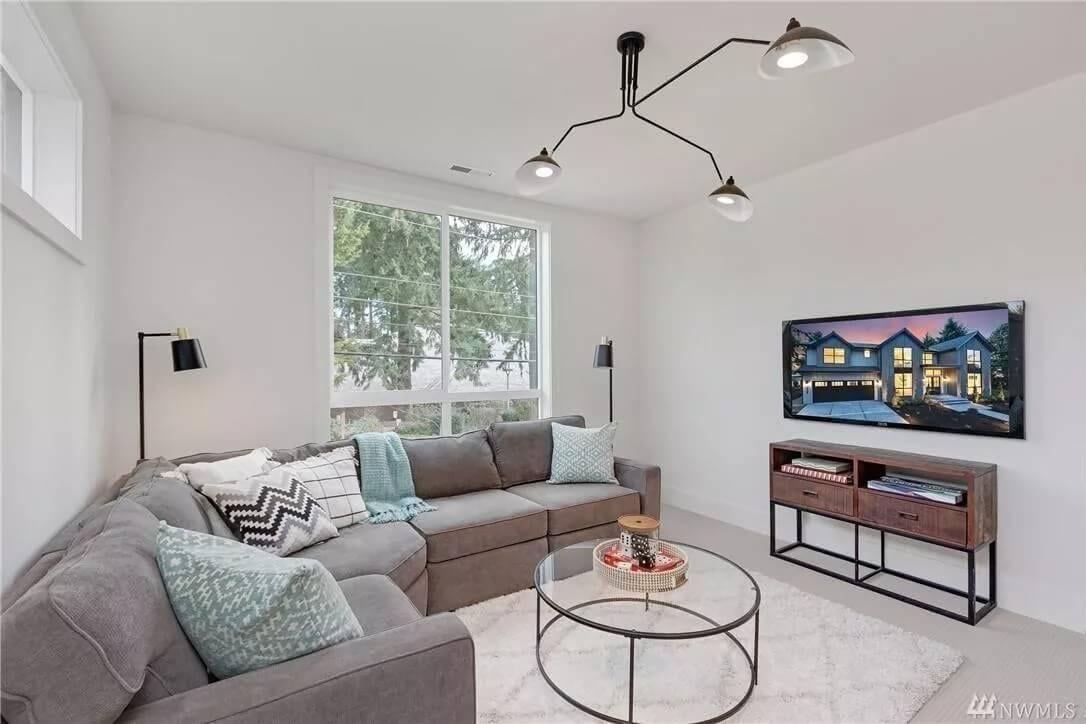 Casual Family Room with Sleek Lighting Fixture and Plush Corner Sofa