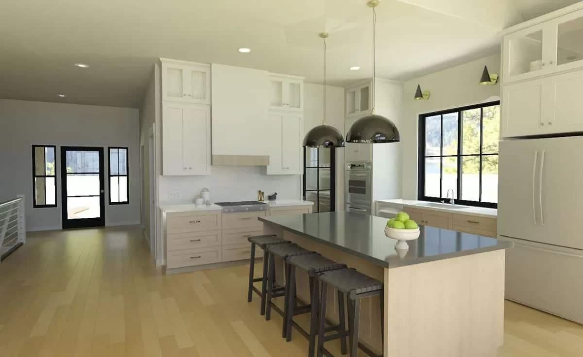 Notice the Sleek Black Pendant Lights Above This Spacious Kitchen Island