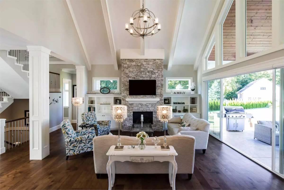 Unwind in This Living Room with a Stunning Stone Fireplace and Vaulted Ceilings