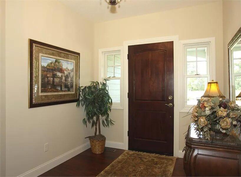 Step Into This Inviting Craftsman Entryway with Elegant Dark Wood Door