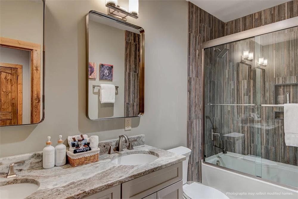 Elegant Bathroom Featuring a Granite Countertop and Warm Wood Accents