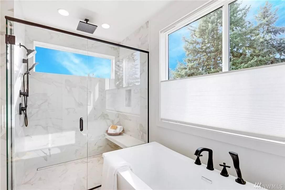 Pristine Bathroom with Sleek Black Fixtures and a Rain Shower