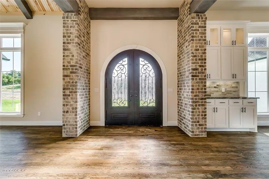 Step Into Elegance with This Arched Doorway and Brick Accents