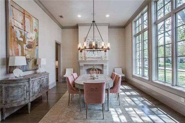 Elegant Dining Room with Pink Chairs and a Statement Chandelier