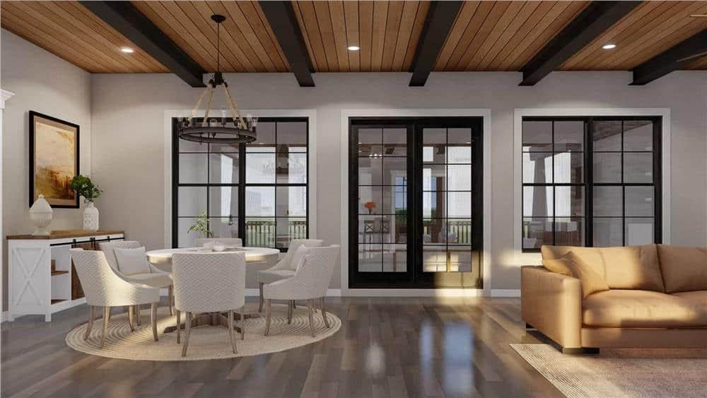 Elegant Dining Area with Bold Black Windows and Wood Beam Ceiling