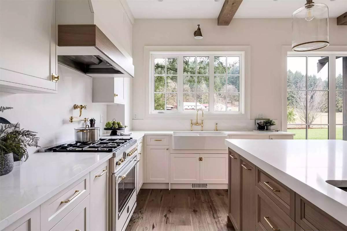 Notice the Farmhouse Sink and Brass Fixtures in This Bright Kitchen