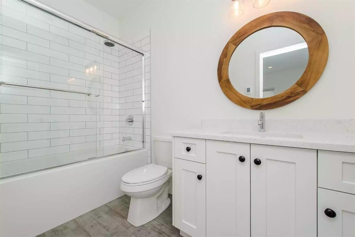 Notice the Bold Wooden Mirror in This Stylish Bathroom