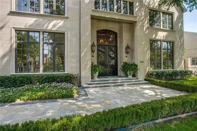 Striking Entrance with Ornate Iron Door and Symmetrical Design