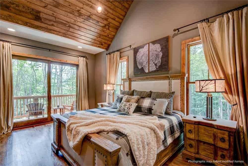 Cozy Bedroom with Vaulted Wood Ceiling and Forest Views