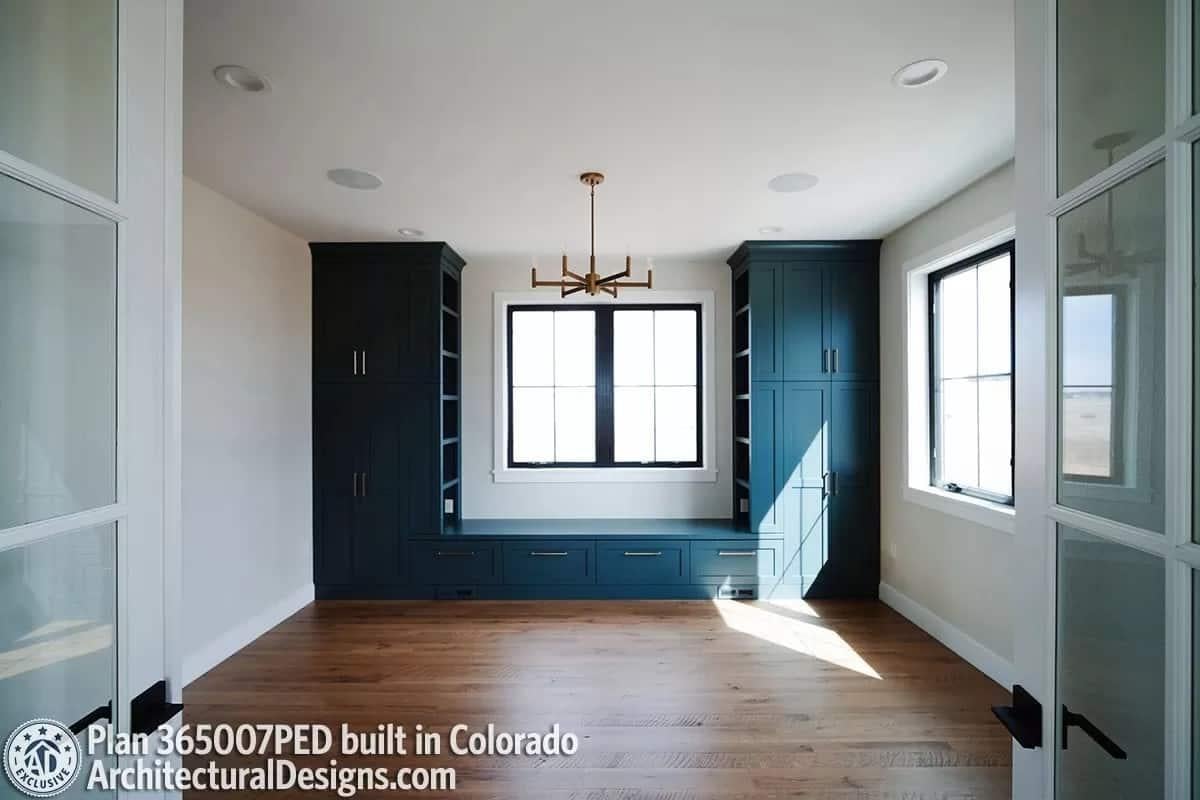 Built-in Cabinets and a Striking Chandelier in a Sunlit Room