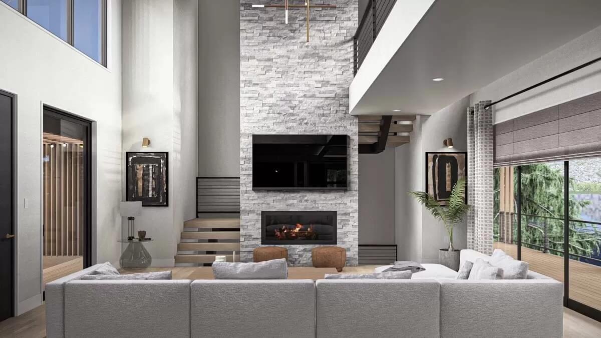 Modern Living Room with Towering Stone Fireplace and Open Staircase