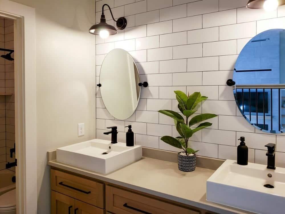 Double Mirrors and Sleek Sconces Elevate This Bathroom