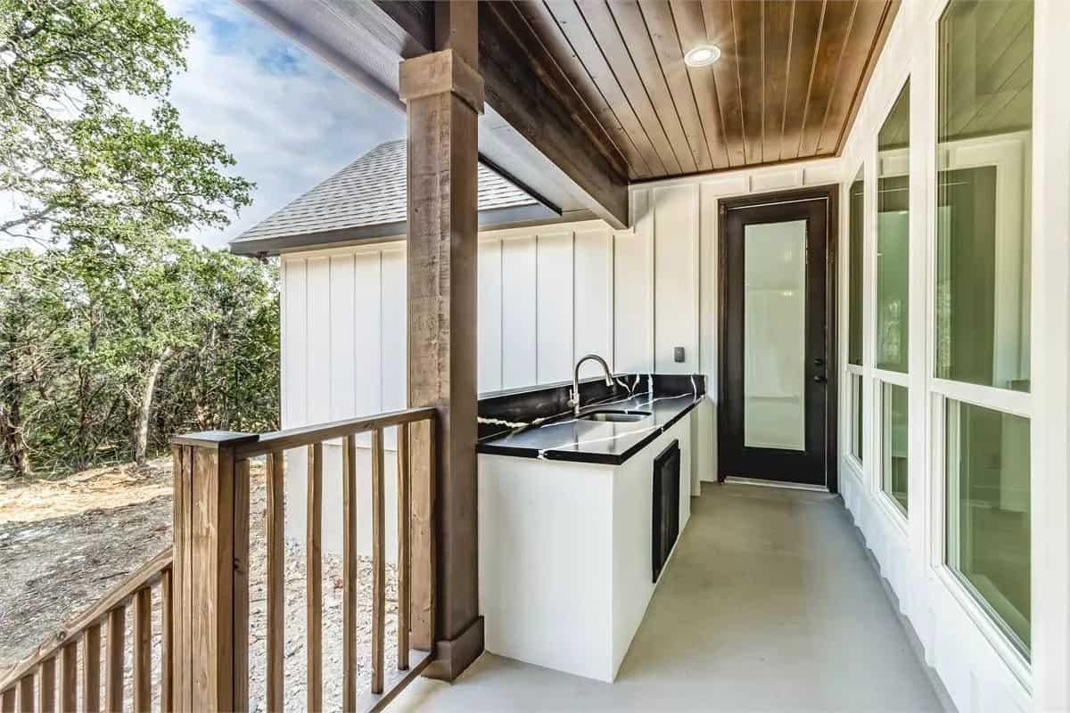 Admire the Sleek Outdoor Kitchen with Dark Countertops