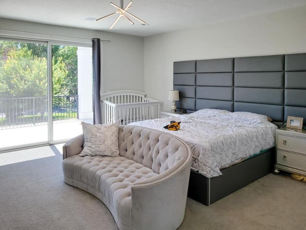 Master Bedroom with Padded Headboard and Stylish Curved Sofa
