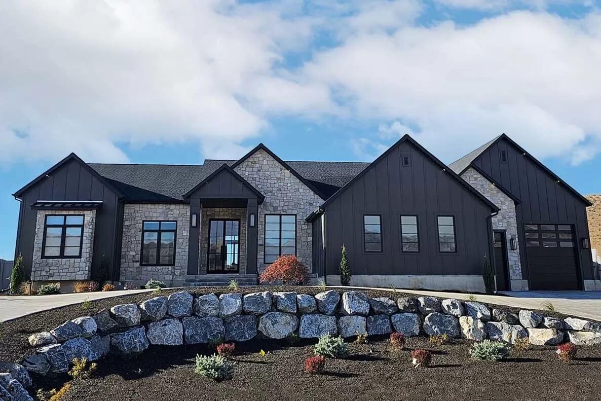 Modern Farmhouse with Striking Stone Facade and Dark Trim