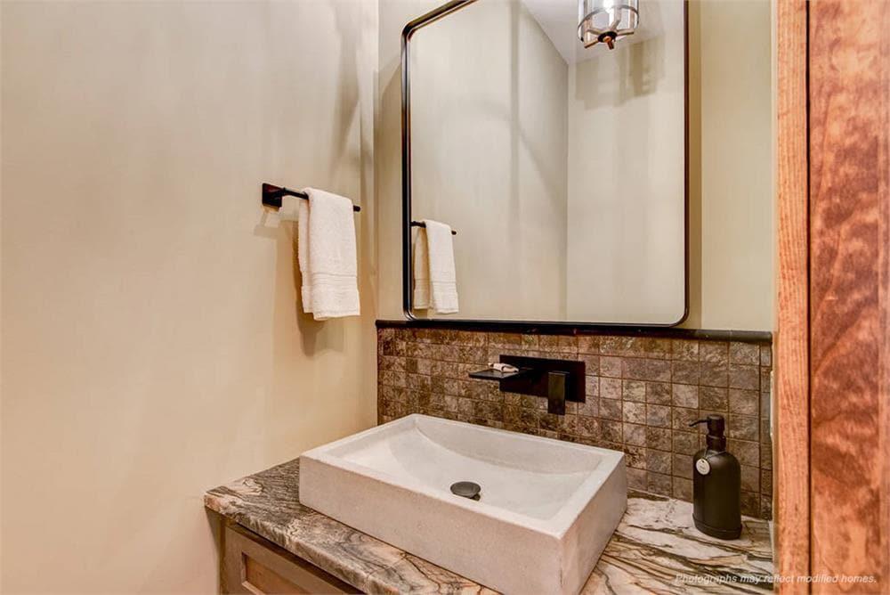 Compact Bathroom with Unique Stone Basin and Subway Tile Backsplash