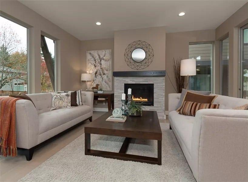 Cozy Living Room with a Contemporary Fireplace and Mirrored Accent