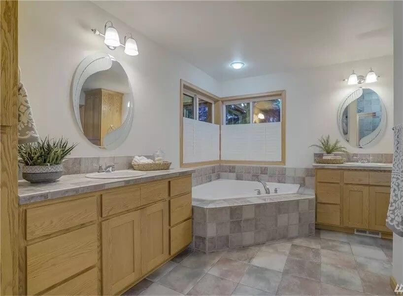 Spacious Bathroom Oasis with a Corner Tub for Ultimate Relaxation