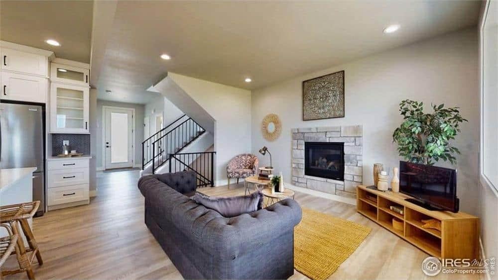 Living Room Comfort with a Stone Fireplace and Cozy Ambiance