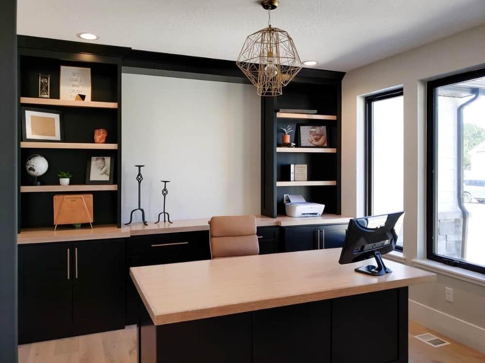 Stylish Home Office with Built-in Shelving and Geometric Lighting